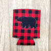 Red and black plaid koozie with black bear on one side.